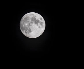 Close up of full moon seen with the telescope from northern hemisphere. Black background.