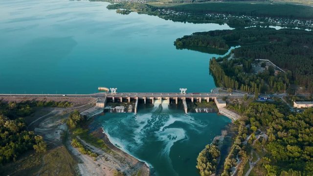 Aerial panoramic view of concrete Dam at reservoir with flowing water, hydroelectricity power station