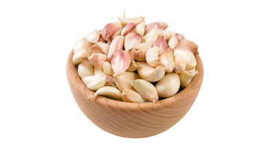 garlic cloves in wooden bowl isolated on white background. 45 degree view. Spices and food ingredients.
