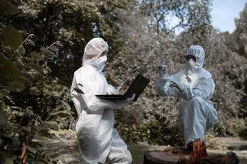 Ecological problem. Pollution. Examine oxygen. Scientist in protective mask and suit taking water samples from river. Chemist makes an analysis of the environment for radiation. Saving planet earth.