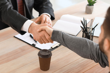 Man shaking hand of notary public in office