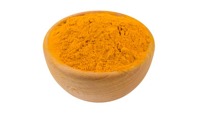 turmeric powder in wooden bowl isolated on white background. 45 degree view. Spices and food ingredients.