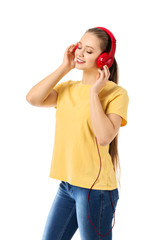 Beautiful young woman listening to music on white background