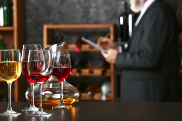 Table with wineglasses and decanter on table in cellar