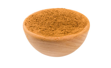ground or milled cinnamon in wooden bowl isolated on white background. 45 degree view. Spices and food ingredients.