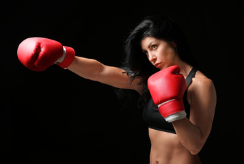 Sporty female boxer on dark background