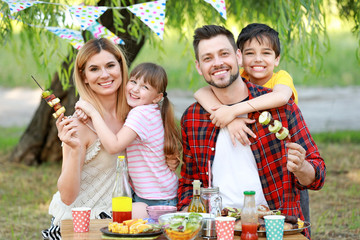 Happy family having picnic on summer day