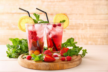Glasses of tasty summer cocktail on wooden table