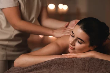 Fotobehang Beautiful young woman receiving massage in spa salon © Pixel-Shot