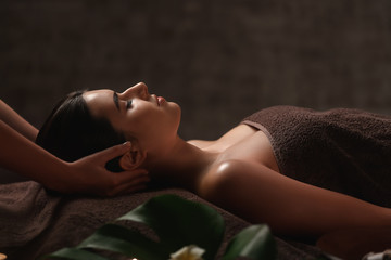 Beautiful young woman receiving massage in spa salon - Powered by Adobe