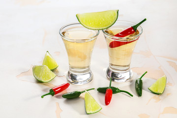 Shots of tequila on light background