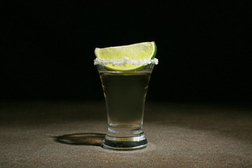Shot of tequila on dark background