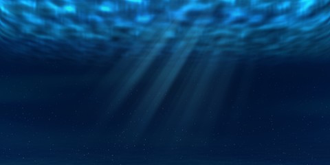 Sun and sunbeams underwater shining through ocean surface. Sea deep underwater