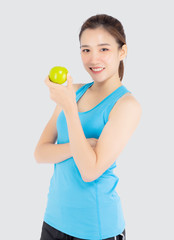 Beautiful portrait young asian woman in sport clothing with satisfied and holding green apple isolated on white background, girl asia have shape and wellness, exercise for fit with health concept.