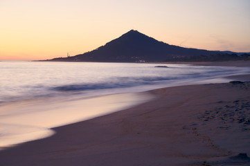 Sunset at the Moledo beach, with a mountain on backgroud