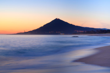 Sunset at the Moledo beach, with a mountain on backgroud