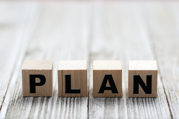Plan word on square wooden blocks on a wooden background