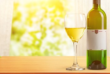 White wine bottle and glass on white background