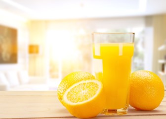 Orange juice and slices of orange on background