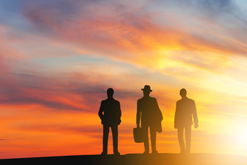 Silhouettes of business man people group with sunset background, Power of success teamwork concept