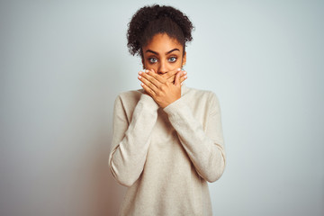 African american woman wearing winter turtleneck sweater over isolated white background shocked covering mouth with hands for mistake. Secret concept.