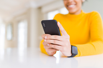 Close up of young african woman using smartphone