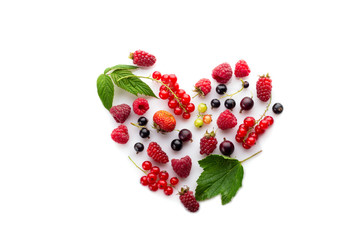 Heart made of different fresh berries. Symbol of love for healthy raw vegan food concept