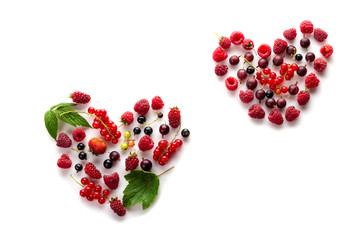 Heart made of different fresh berries. Symbol of love for healthy raw vegan food concept
