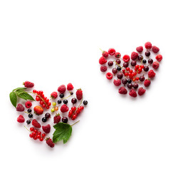 Heart made of different fresh berries. Symbol of love for healthy raw vegan food concept