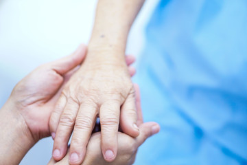 Holding Touching hands Asian senior or elderly old lady woman patient with love, care, helping, encourage and empathy at nursing hospital ward : healthy strong medical concept 
