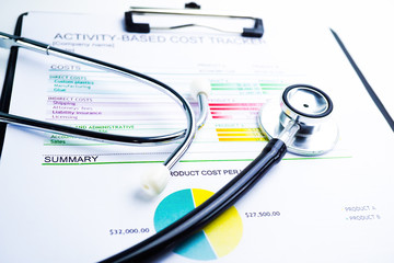 Stethoscope, Charts and Graphs spreadsheet paper, Finance, Account, Statistics, Investment, Analytic research data economy spreadsheet and Business company concept.