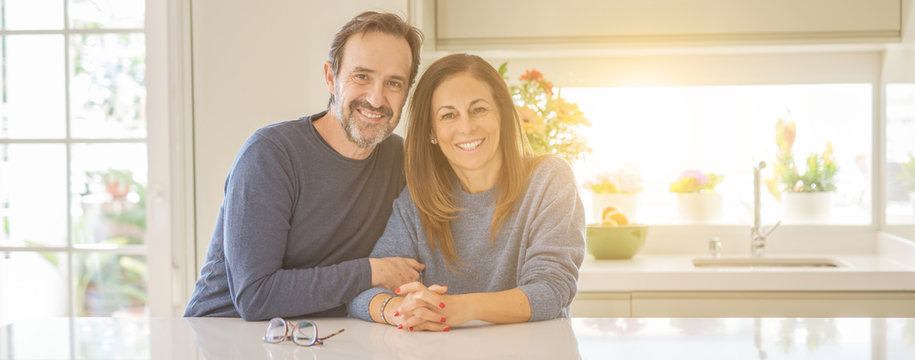 Romantic middle age couple sitting together at home