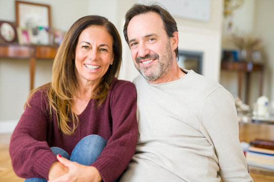 Beautiful romantic couple sitting together on the floor at home