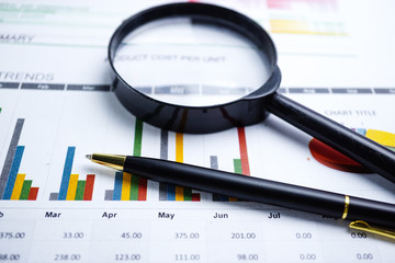 Magnifying glass on charts graphs spreadsheet paper. Financial development, Banking Account, Statistics, Investment Analytic research data economy, Stock exchange trading, Business office company meet