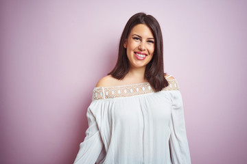 Fototapeta premium Young beautiful brunette woman over pink isolated background with a happy and cool smile on face. Lucky person.