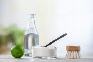 Natural cleaner. Vinegar, baking soda, salt, lemon.homemade grey wooden background