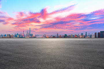Empty race track and modern city skyline in Shanghai at sunset,China