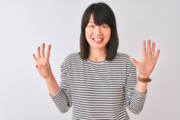 Young beautiful chinese woman wearing black striped t-shirt over isolated white background showing...