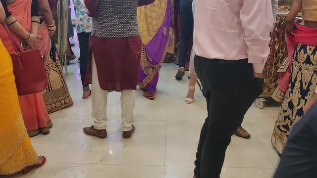 people dressed for a wedding moving inside a banquet hall in a indian marriage function