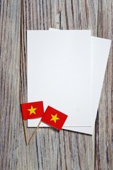 September 2, July 27, happy independence day Vietnam. memorial day for independence. the concept of patriotism. flags with white sheets of paper on a wooden background