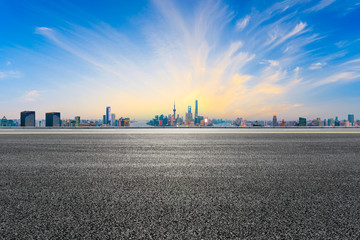 Empty asphalt highway and modern city skyline in Shanghai at sunset,China