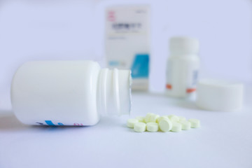 pills and bottle on white background