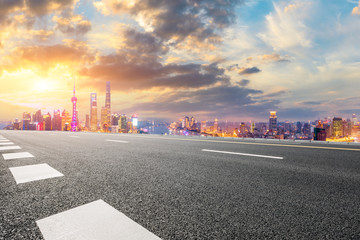 Fototapeta na wymiar Empty asphalt highway and modern city skyline in Shanghai at sunset,China