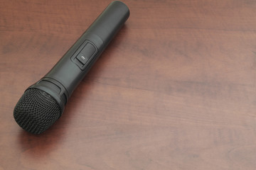 Black microphone on brown table