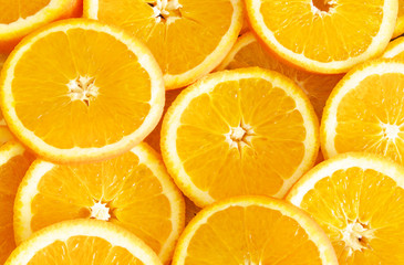 Slices of ripe orange fruits as background