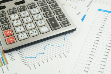 Naklejka na ściany i meble Business concept, calculator on financial charts and graphs