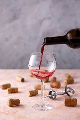 Red wine is poured into a glass. The concept of winemaking. Place under your text.