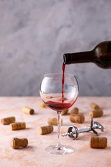 Red wine is poured into a glass. The concept of winemaking. Place under your text.