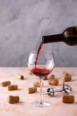 Red wine is poured into a glass. The concept of winemaking. Place under your text.