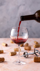 Red wine is poured into a glass. The concept of winemaking. Place under your text.